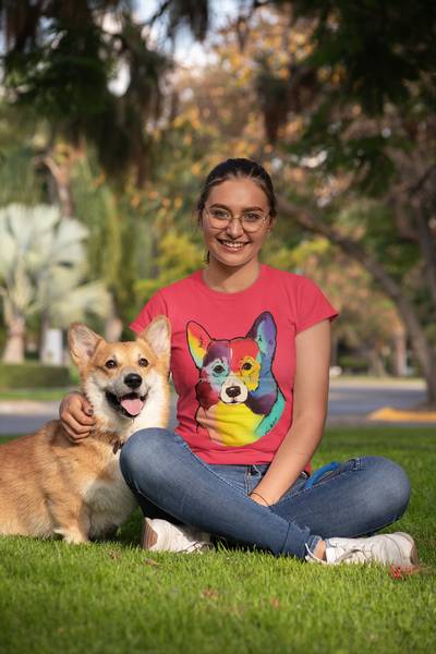 woman with a smiling Corgi dog next to her 600