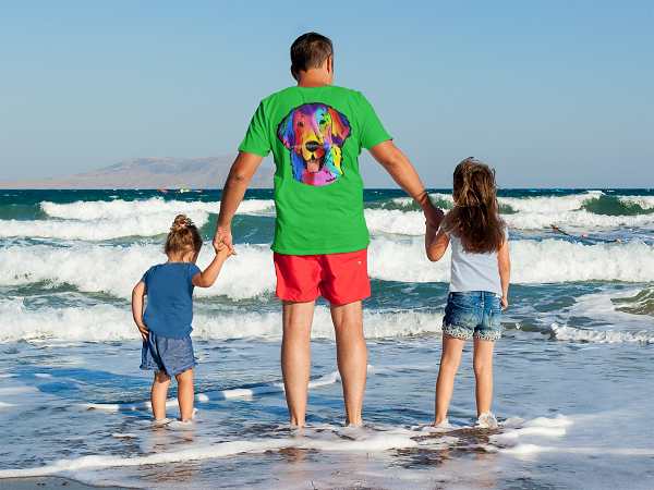 father at the beach with his daughters flat coated retriever 1 600